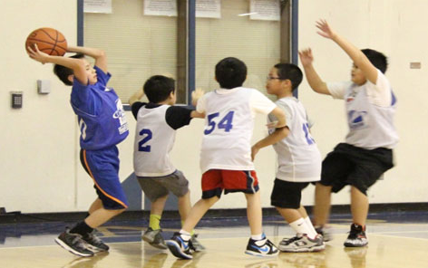 group of kids play basketball